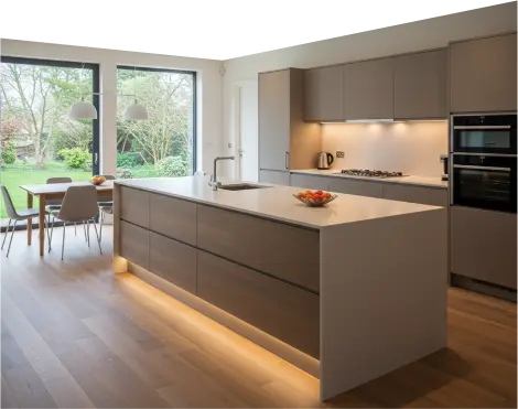 Sleek kitchen with island, wooden flooring, and large windows.